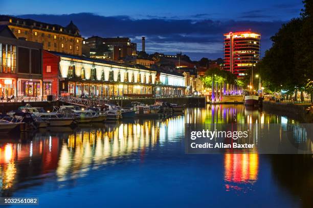 the redeveloped watershed district of bristol illuminated at dusk - bristol fotografías e imágenes de stock