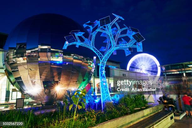 the 'energy tree' sculpture in the redeveloped millennium square at night - bristol skyline stock pictures, royalty-free photos & images