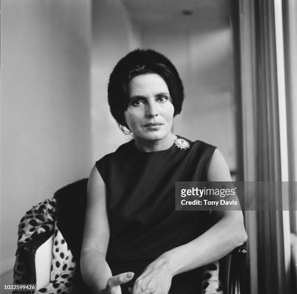 Portuguese fado singer Amalia Rodrigues posed seated in a chair on 15th April 1963.