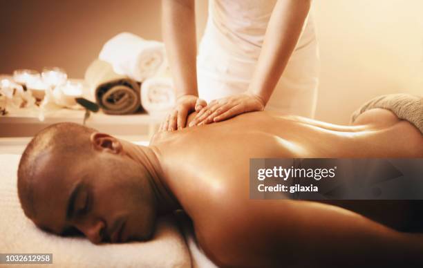 relaxing back massage. - man massage stock pictures, royalty-free photos & images