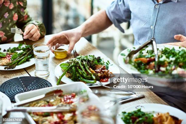 cropped view of table laid with crockery and fresh homemade vegetarian food - vegan 個照片及圖片檔