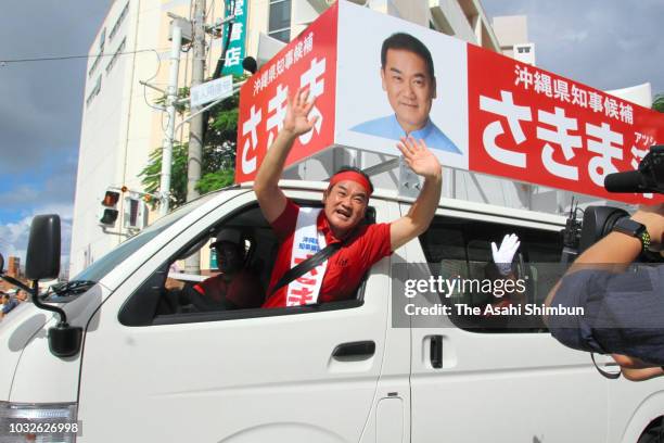 Ruling Liberal Democratic Party backed candidate Atsushi Sakima departs his election campaign headquarters as the Okinawa gubernatorial election...