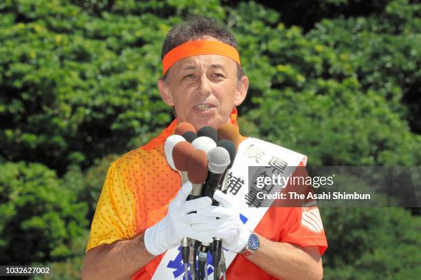 Supporters of opposition 'All Okinawa' movement backed candidate Denny Tamaki makes a street speech as the Okinawa gubernatorial election officially...