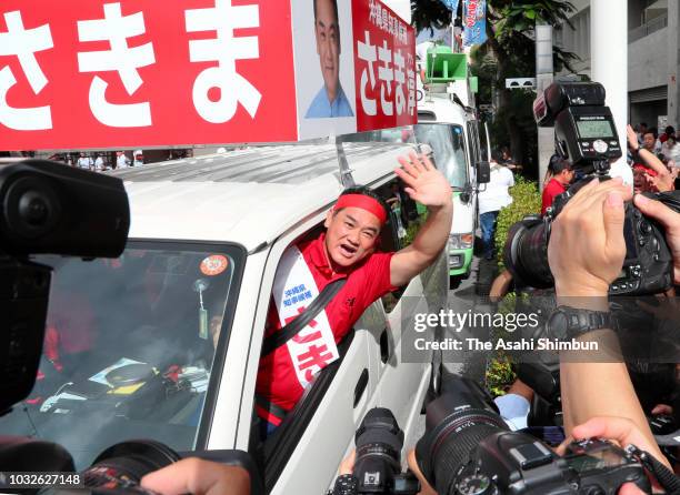 Ruling Liberal Democratic Party backed candidate Atsushi Sakima departs his election campaign headquarters as the Okinawa gubernatorial election...