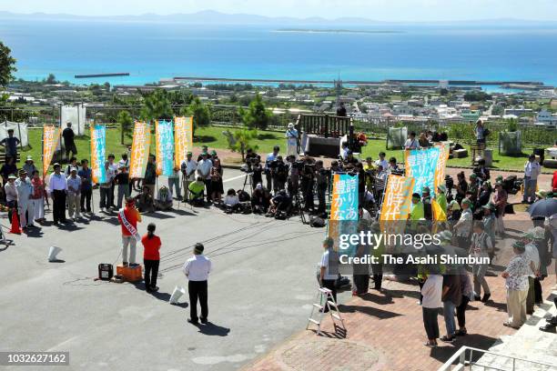 Supporters of opposition 'All Okinawa' movement backed candidate Denny Tamaki makes a street speech as the Okinawa gubernatorial election officially...