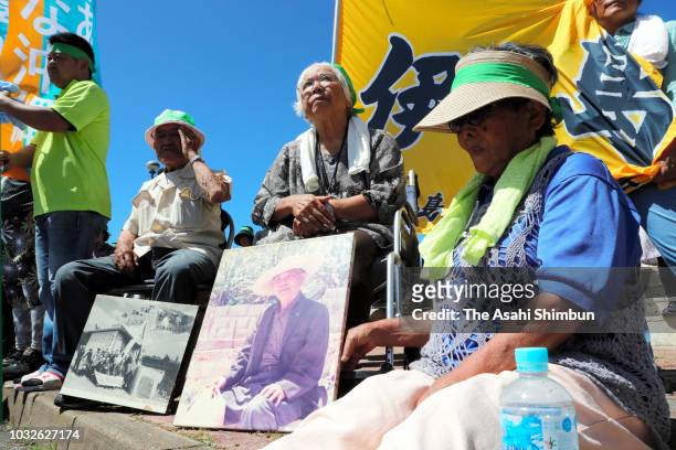 Supporters of opposition 'All Okinawa' movement backed candidate Denny Tamaki wait for a street speech as the Okinawa gubernatorial election...