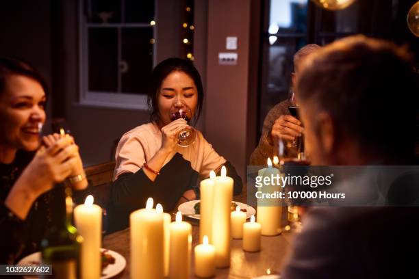 korean woman drinking wine with friends at dinner party - dinner guest stock pictures, royalty-free photos & images