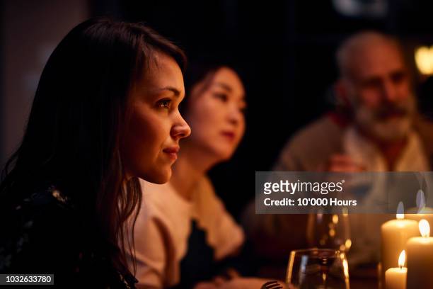 serene looking woman at dinner party listening attentively - evening meal restaurant stock pictures, royalty-free photos & images