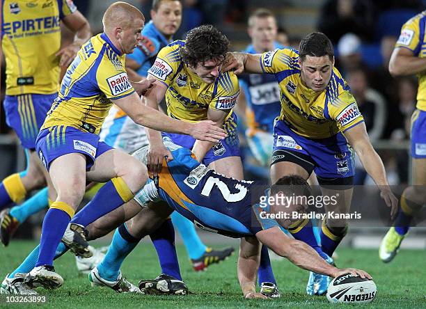 Mark Minichiello of the Titans reaches out to score a try during the round 22 NRL match between the Gold Coast Titans and the Parramatta Eels at...