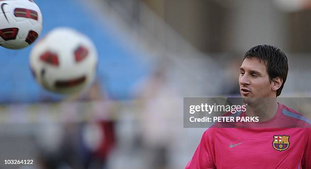 Barcelona's Argentinian player Lionel Messi kicks the ball during a light training session with team mates at the Worker's Stadium in Beijing on...