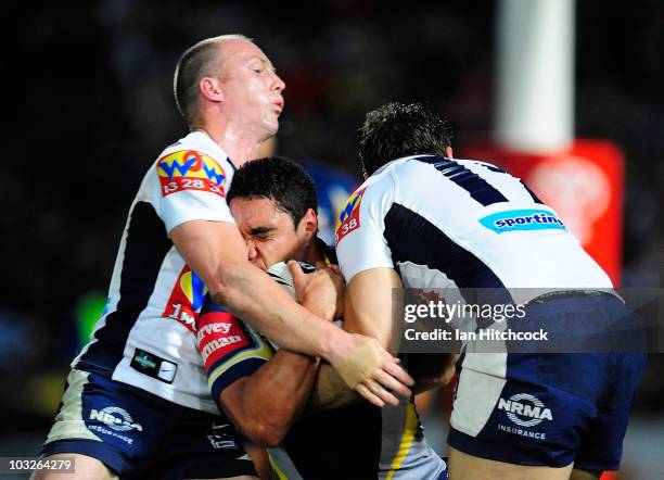 Willie Tonga of the Cowboys is tackled by Darren Lockyer and Scott Anderson of the Broncos during the round 22 NRL match between the North Queensland...