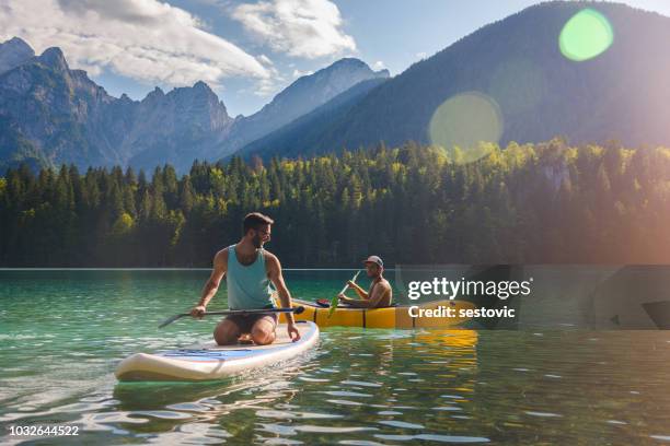 friends having fun on the lake - canoe stock pictures, royalty-free photos & images