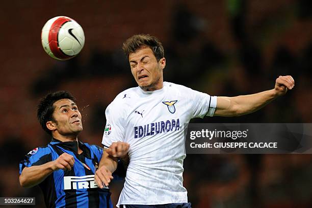 Inter Milan midfielder Luis Jimenez of Chile jumps for the ball with SS Lazio defender David Rozenhal of Czek Republic during their Italian cup...