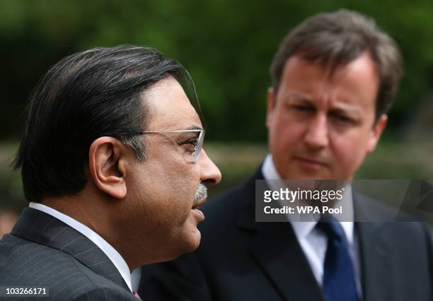 British Prime Minister David Cameron stands with Pakistan's President Asif Ali Zardari as they talk to the media on August 6, 2010 at Chequers near...