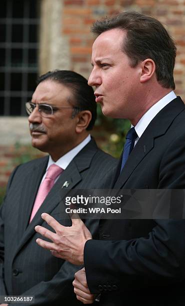 British Prime Minister David Cameron stands with Pakistan's President Asif Ali Zardari as they talk to the media on August 6, 2010 at Chequers near...