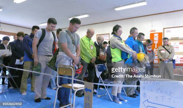 Volunteers observe a minute of silence a week after the magnitude 6.7 earthquake on September 13, 2018 in Atsuma, Hokkaido, Japan. Concerns are...