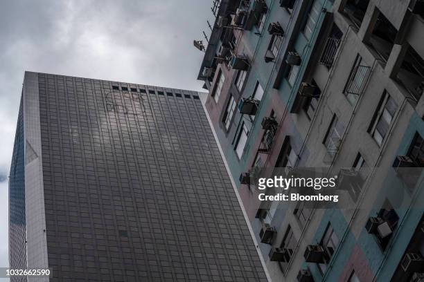 The Sun Hung Kai Centre building, which houses the Sun Hung Kai Properties Ltd. Headquarters, left, stands next to a residential building in Hong...