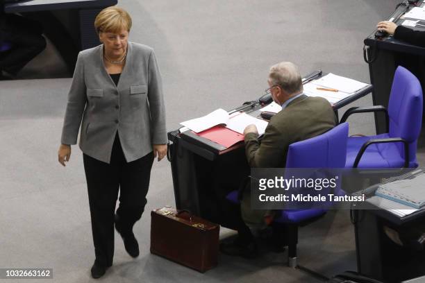 German Chancellor Angela Merkel passes by the far right party, AfD, leader Alexander Gauland as she leaves a session of the German Parliament or...