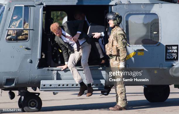 Prince Harry, Duke of Sussex arrives by helicopter as he visits the Royal Marines Commando Training Centre on September 13, 2018 in Lympstone, United...