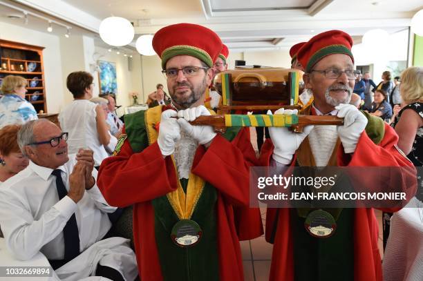Members of the brotherhood carry a tripe pot during the 38th annual general meeting of the Brotherhood of the "Tripiere Fertoise", a Normandy's...