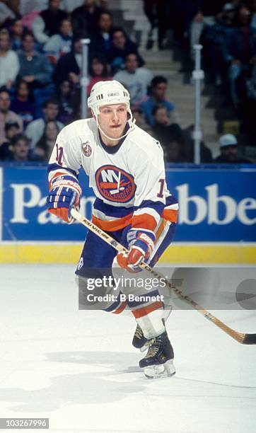 Darius Kasparaitis of the New York Islanders skates on the ice during an NHL game circa 1993 at the Nassau Coliseum in Uniondale, New York.