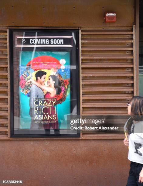 Poster displayed outside a movie theater advertises a coming attraction, the film 'Crazy Rich Asians'.