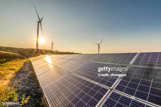 solar energy and wind power stations - wind power stock pictures, royalty-free photos & images