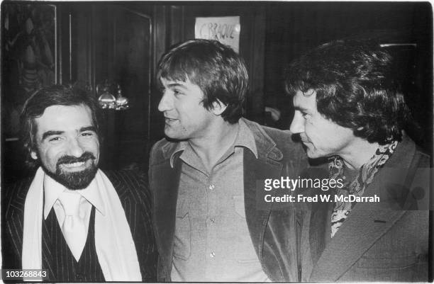 At a party in celebration of his soon-to-be-released concert film 'The Last Waltz,' American film director Martin Scorsese poses with two of his...