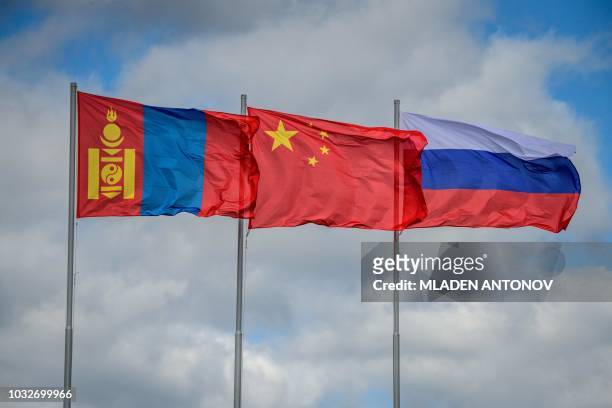 The flags of Mongolia, China and Russia fly in the wind during the Vostok-2018 military drills at Tsugol training ground not far from the borders...
