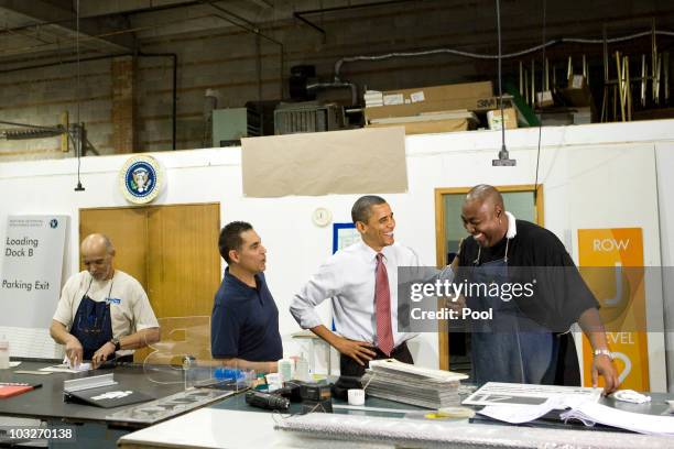 President Barack Obama speaks with employee Max White as he tours Gelberg Signs with company Principal Luc Brami during a visit to highlight the...