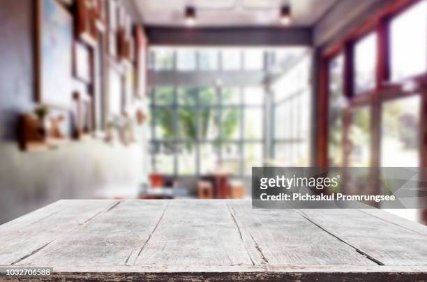 close-up of wooden table against window at home - focus on foreground stock pictures, royalty-free photos & images