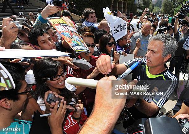 Real Madrid coach Jose Mourinho signs autographs for fans after a press conference at the UCLA campus on the eve of his teams friendly against the LA...