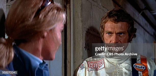Steve McQueen as race car driver Michael Delaney talking to Elga Andersen as Lisa Belgetti in the movie, "Le Mans", 1971. Image is a frame grab.