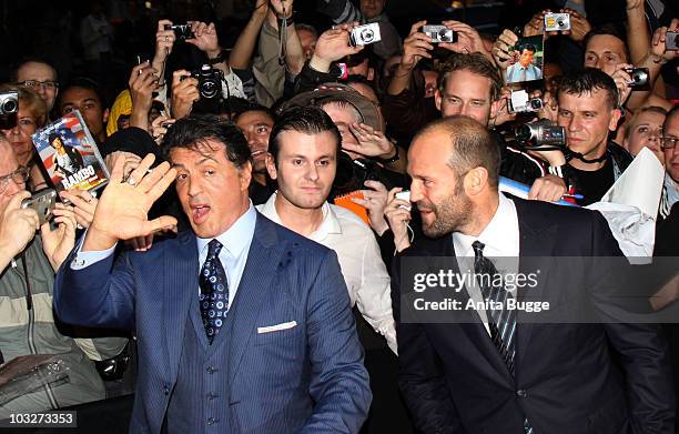 Actors Sylvester Stallone, Jason Statham and Dolph Lundgren mingle with the fans during the Germany Premiere of 'The Expendables' at the Astor Film...