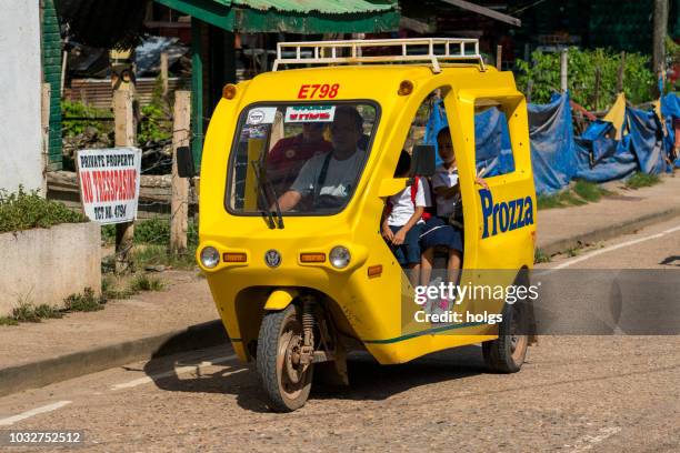 electric tricycle with passengers on the street in coron, palawan, philippines - philippines tricycle stock pictures, royalty-free photos & images