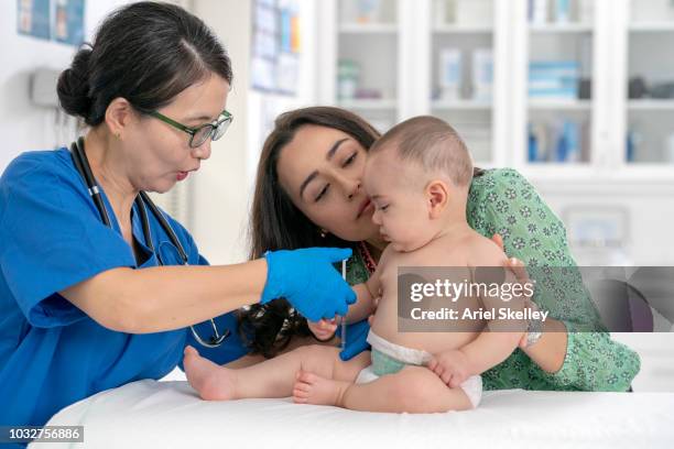 baby getting medical exam - ariel shot stockfoto's en -beelden