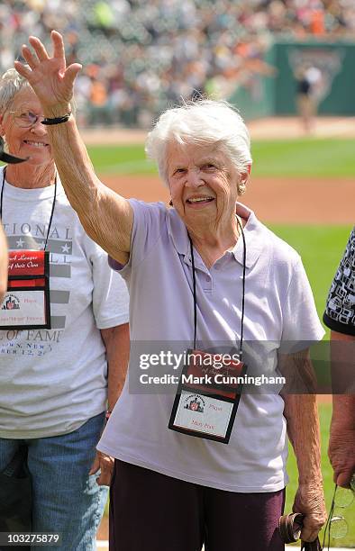 Former member of the All-American Girls Professional Baseball League Mary Pratt waves to the crowd during a reunion ceremony before the game between...
