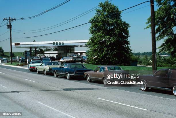 1970s CARS LINED UP AT GAS PUMPS GAS STATION OIL CRISIS OPEC SHORTAGE