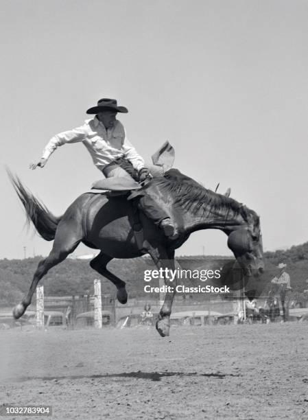 1950s COWBOY RIDING A HORSE BAREBACK ON A WESTERN RANCH USA