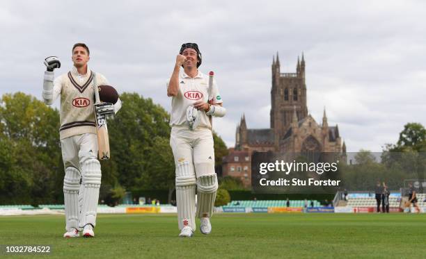 Surrey batsmen Morne Morkel and Rikki Clarke leave the field together after Surrey had won the match to win the 2018 Championship after day four of...