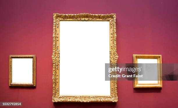 three empty blank picture frames hanging on wall. - inauguración-de-galería fotografías e imágenes de stock