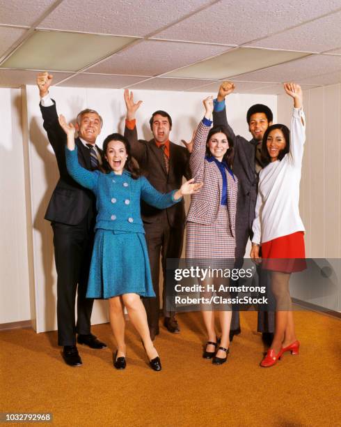 1970s SIX BUSINESS MEN AND WOMEN WAVING RAISED HANDS STANDING SMILING HAPPY LOOKING AT CAMERA