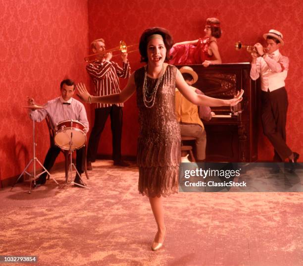 1920s SPEAKEASY SCENE WOMAN FLAPPER SILVER BEADED DRESS DOING THE CHARLESTON IN FRONT OF A BAND