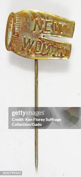 Red and gold feminist stick pin, in the shape of a pair of trousers, with the text New Woman, referencing the late 19th-century feminist ideal of the...