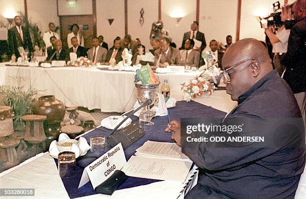 President Laurent Kabila of the Democratic Republic of Congo reads notes, 07 September during a summit meeting in Victoria Falls. Kabila and five...
