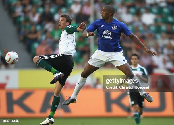 Mario Mandzukic of Wolfsburg and Sylvain Distin of Everton go up for a header during the pre-season friendly match between VfL Wolfsburg and Everton...