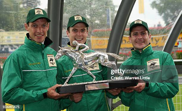 Richard Hughes, Fran Berry and Pat Smullen of Ireland pose with the trophy after winning the Shergar Cup at Ascot Racecourse on August 7, 2010 in...