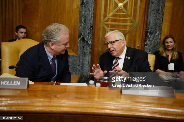 Chairman of the US Senate Committee on the Budget, Mike Enzi , right, and Senator Chris Van Hollen, a Democrat from Maryland, speak to each other...
