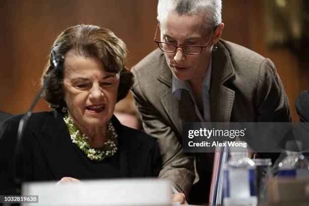 Committee ranking member U.S. Sen. Dianne Feinstein listens to an aide during a markup hearing before the Senate Judiciary Committee September 13,...
