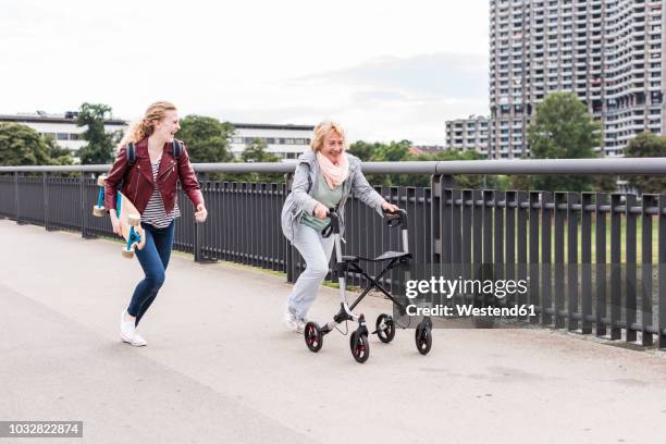 grandmother and granddaughter having fun together - oma rollator stockfoto's en -beelden